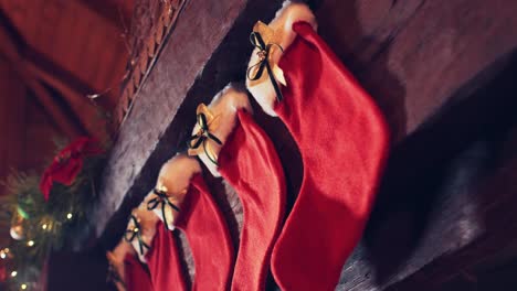 red christmas stockings for gifts on the fireplace near the christmas decorations