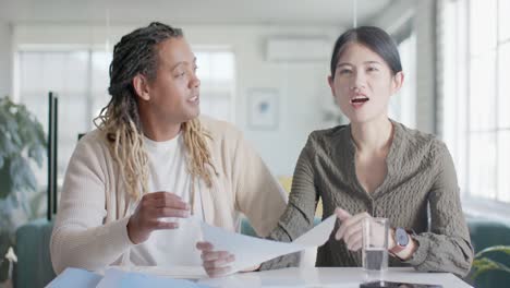 portrait of two happy diverse casual business colleagues making video call in office in slow motion