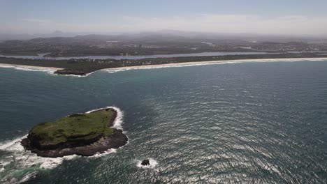 fingal head coastline with cook island in foreground. northern rivers region of nsw, australia. aerial sideways shot