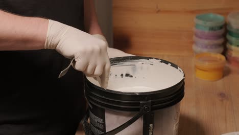 a worker kneads the paint for painting the walls