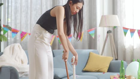 woman cleaning up after a party