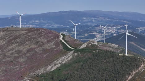 a wind turbine farm on the top of a mountain in portugal