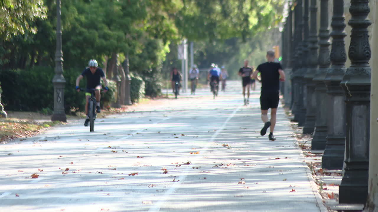 People Running and Biking in a Park
