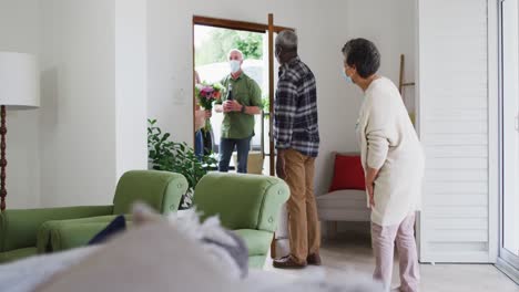 two diverse senior couples greeting each other at home