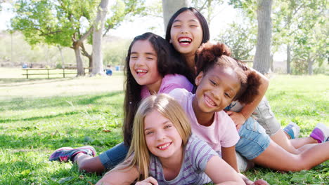 portrait of group of young girls with friends having fun in park shot in slow motion