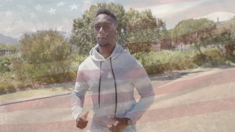 animation of flag of usa over african american man walking on street