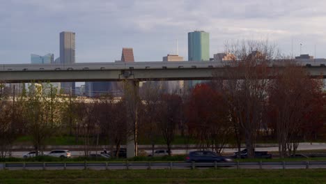 Drone-shot-from-wooded-area-that-reveals-downtown-Houston,-Texas