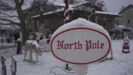 christmas lawn decorations in a residential neighborhood during a light snowfall in canada