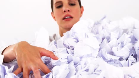 businesswoman trapped on a pile of waste papers