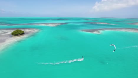 aerial view tracking man kitesurf turquoise caribbean sea water, los-roques archipelago