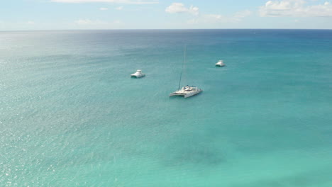 Luxurious-catamaran-yachts-anchoring-in-tropical-caribbean-sea-waters