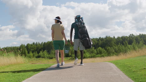 Caucasian-woman-and-african-american-man-on-the-golf-course.