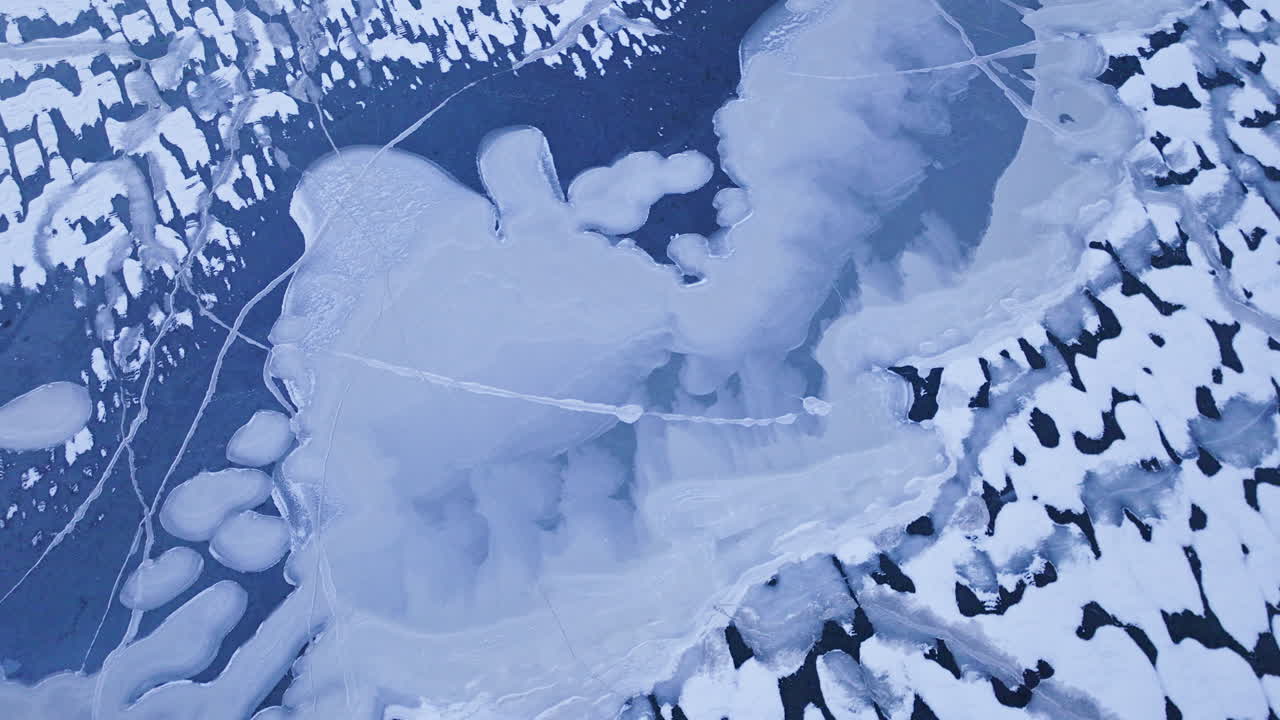 A drone's perspective as it glides over massive ice masses on the water