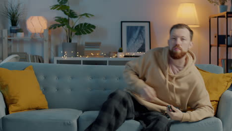 Man relaxing on a couch watching TV