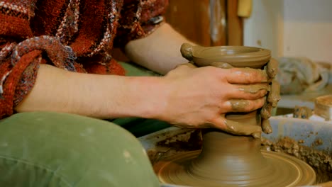 professional male potter working in workshop