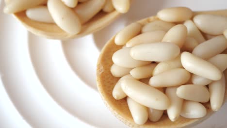 pine nuts in wooden spoon