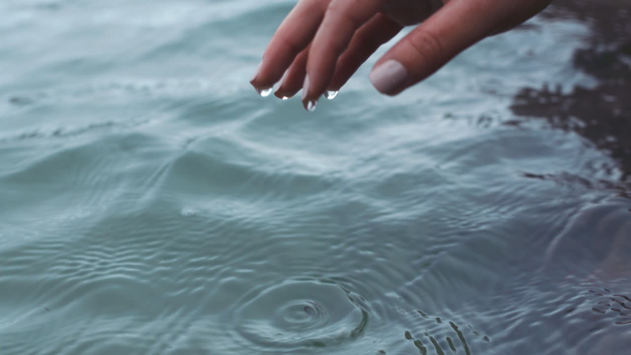Hands, water and nature with the hand of a woman