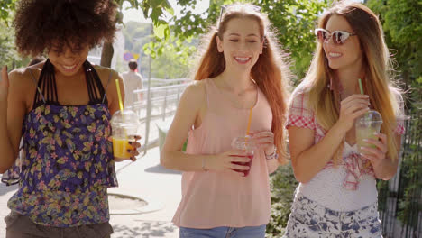 women walking and having beverages