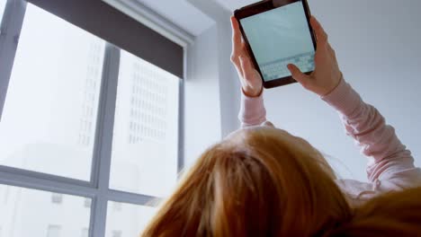 Woman-using-digital-tablet-in-bedroom-4k