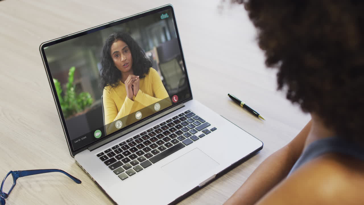 African american businesswoman using laptop for video call with biracial business colleague