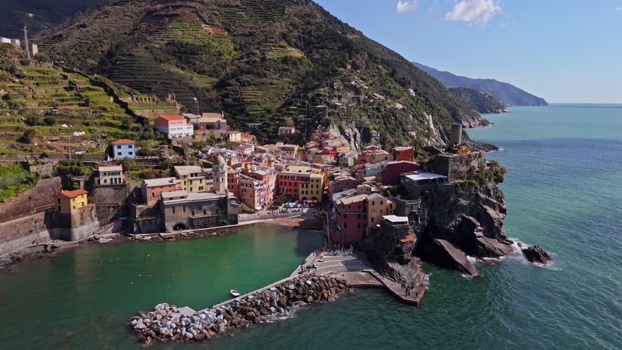 Vernazza, Cinque Terre, Italy, showcasing the vibrant coastal village with colorful buildings, clear blue water, and the natural beauty of the region