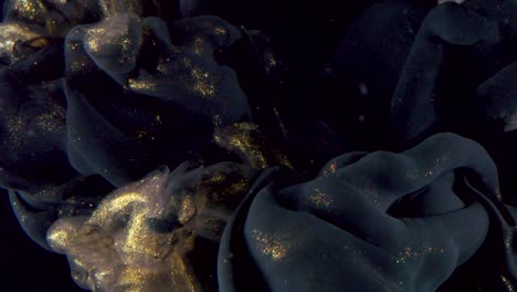 lujosas nubes de tinta dorada pálida y negra giran, arte macro líquido abstracto