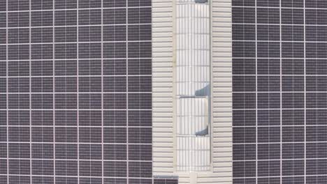 aerial view of solar panels on a large industrial rooftop