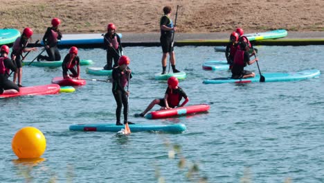 kids learning paddle boarding in brighton, england