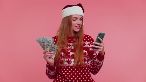 Woman-in-Christmas-sweater-looking-smartphone-sincerely-rejoicing-win-success-luck-receiving-money