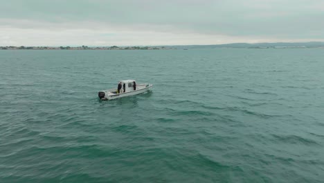 Small-research-boat-floating-in-the-Mediterranean-Sea,-Sète,-France