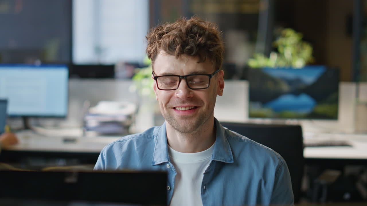 Smiling programmer working computer corporate workplace closeup. Man looking pc
