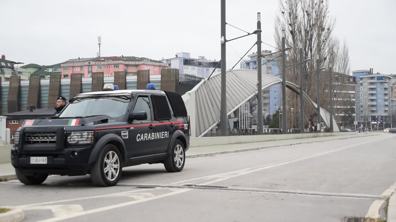 Italian police officer for nato standing on the brigde in Mitrovica, Kosovo