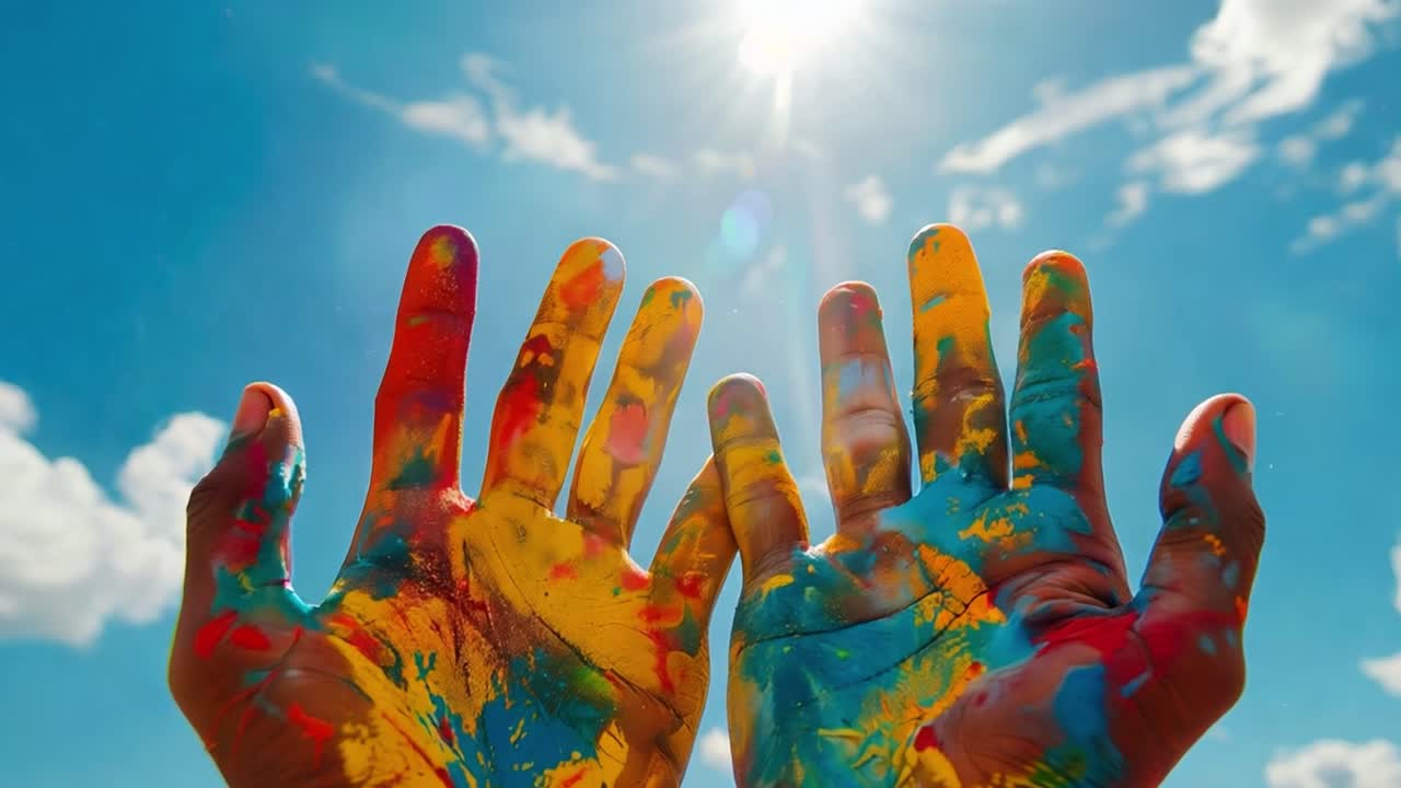 Colorful Painted Hands Reaching for the Sun in a Bright Blue Sky