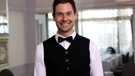 handsome waiter showing dessert plates