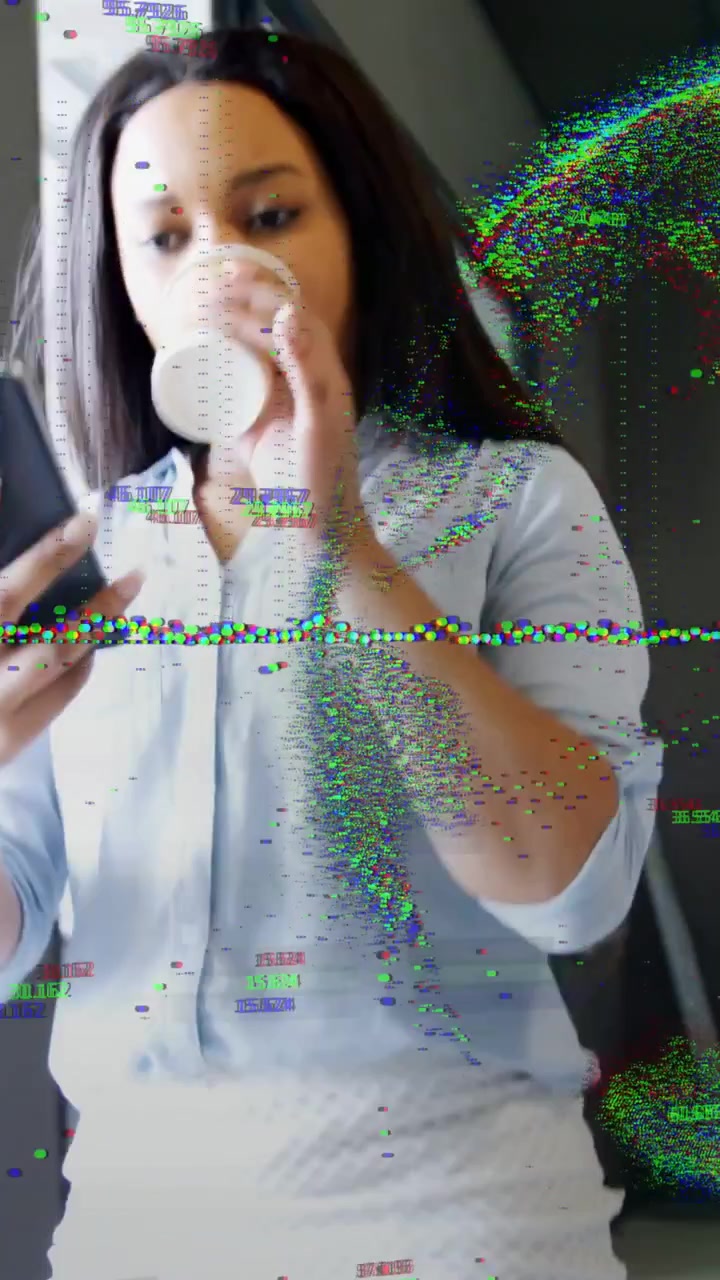 Vertical video: Woman entering tech sipping and checking texts, tracking points overlaying subject