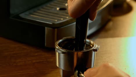 Tamping-coffee-in-a-portafilter-4k