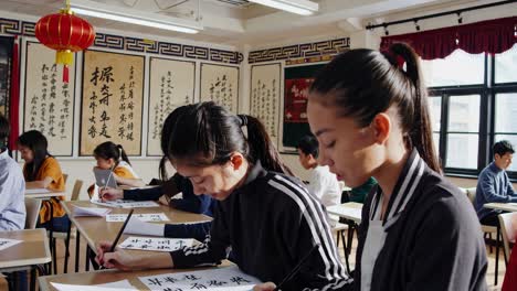 students practicing chinese calligraphy in a classroom