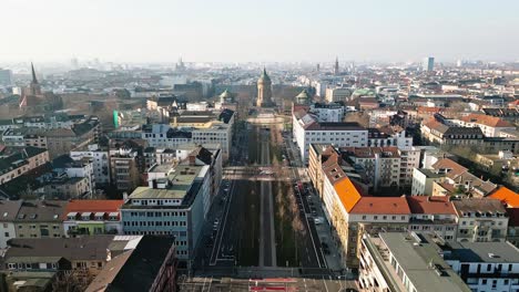 drone flight over mannheim's augustaanlage towards the iconic wasserturm on a clear, sunny winter day.