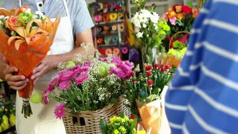 Florist-giving-bouquet-of-flower-to-customer