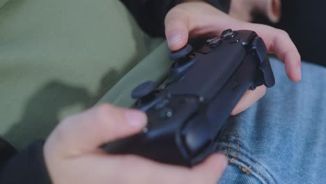 close-up on person's hands using a video game controller