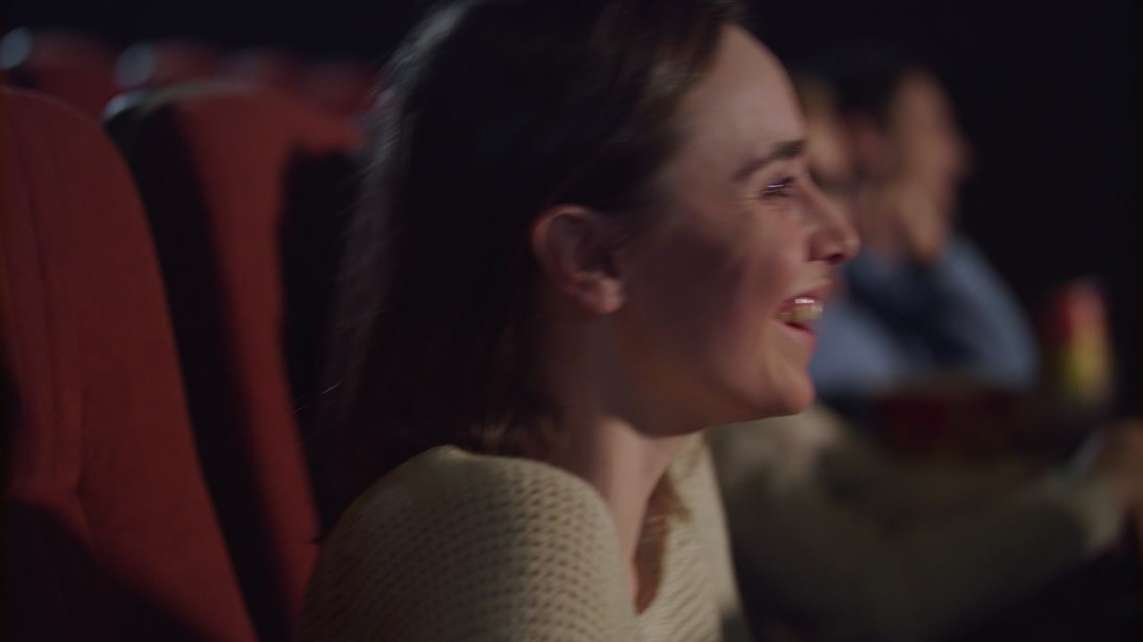 cara de mujer viendo una película divertida en el cine. gente del cine viendo una película de comedia