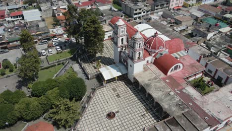 aerial-orbit-shot-of-main-church-garden-in-Almoloya,-Jalisco-mexico