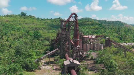 An-impressive-shot-of-an-abandoned,-rust-covered-overgrown-factory-in-Surigao-Del-Norte---Philippines