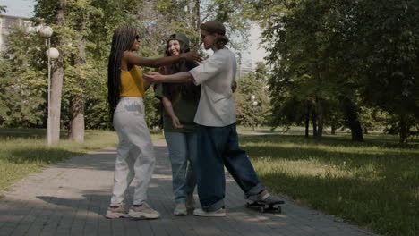 friends greeting and hugging in a park