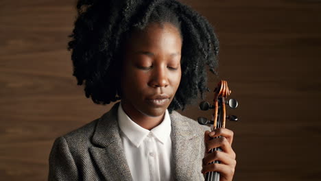 portrait of classical musician holding violin african american woman