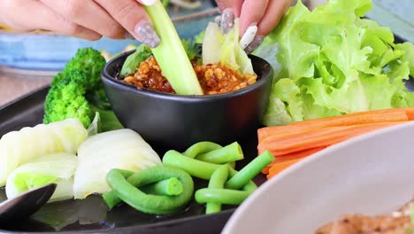 demonstrating chili dip preparation with vegetables