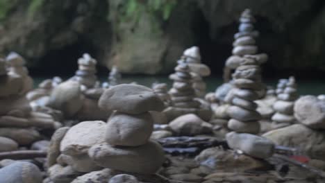 serene stone cairns in a cave near water
