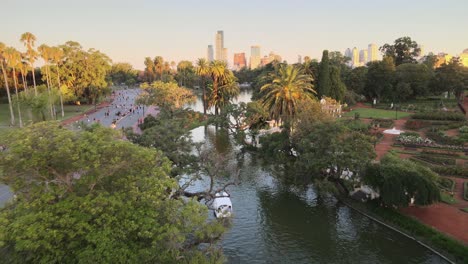 Aerial-dolly-out-of-Rosedal-gardens-pond-near-Palermo-Woods-pedestrian-street-at-golden-hour,-Buenos-Aires