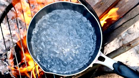 top view, water is boiling in a pot.