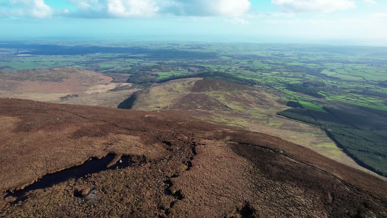 Ireland Mountains drone flying over beat bog on mountains with coast in background Comeragh mountains waterford ireland epic Locations and Landscapes